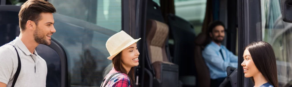 A group of tourists boarding a luxury coach in Melbourne for a city tour. Group Transport in Melbourne